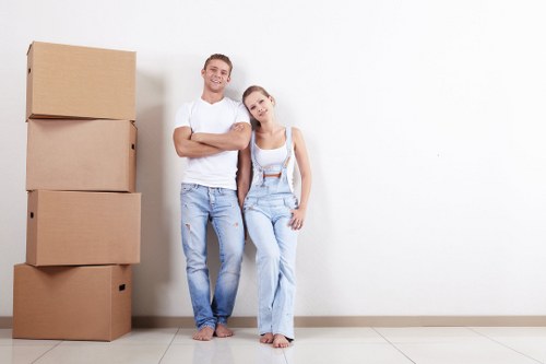 Removal team preparing a flat move in Belmont with boxes and furniture