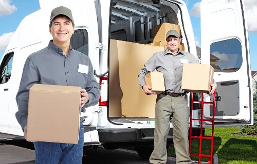 Packed moving boxes and furniture ready for transport in Belmont